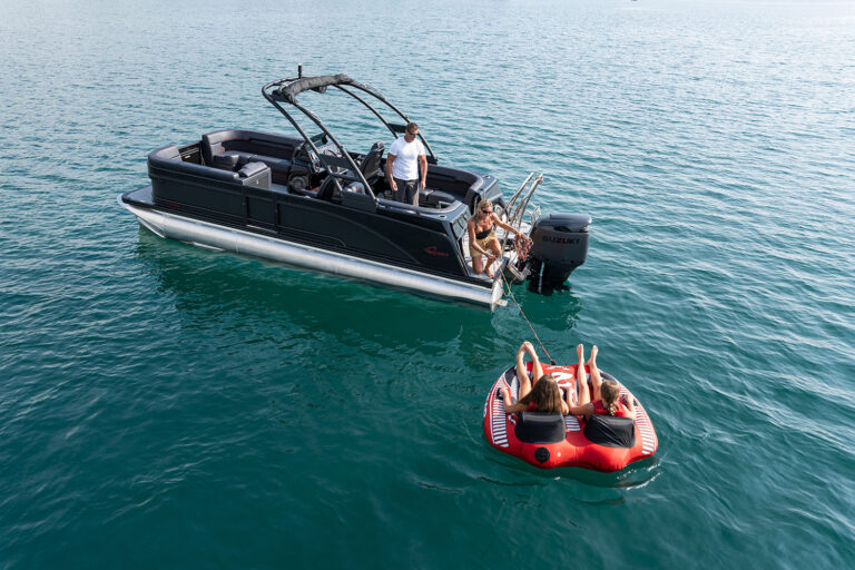 Qwest Pontoons M-Class RLS shown in the Limited black and red package features comfortable benches in all 4 corners and an open center walkway for relaxing in comfort.