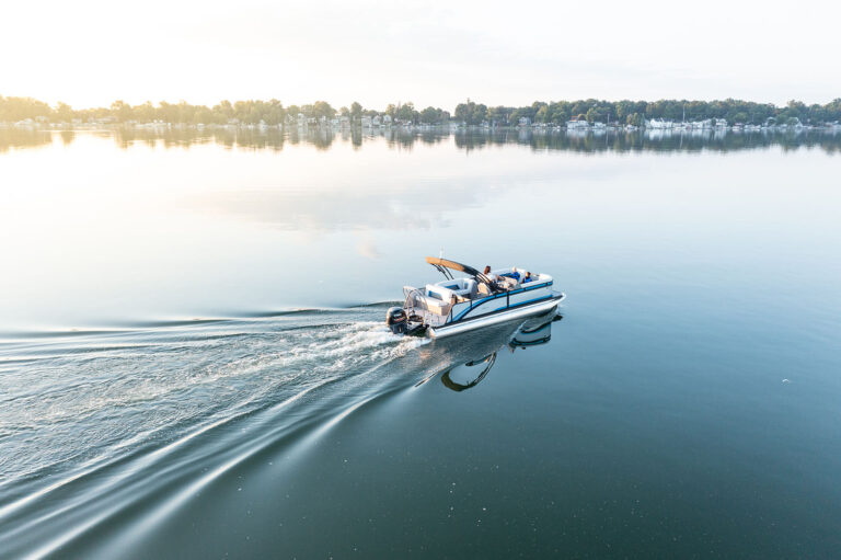 Qwest Pontoons E-Class Lanai features comfortable seating throughout with benches in the front and a rear facing bench on the open back deck.