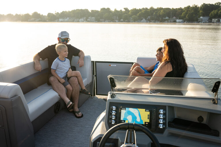 Qwest Pontoons E-Class Lanai features comfortable seating throughout with benches in the front and a rear facing bench on the open back deck.