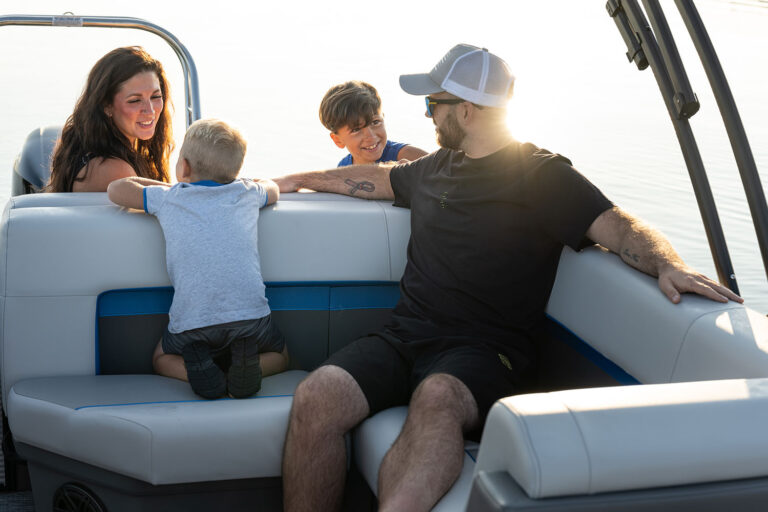 Qwest Pontoons E-Class Lanai features comfortable seating throughout with benches in the front and a rear facing bench on the open back deck.