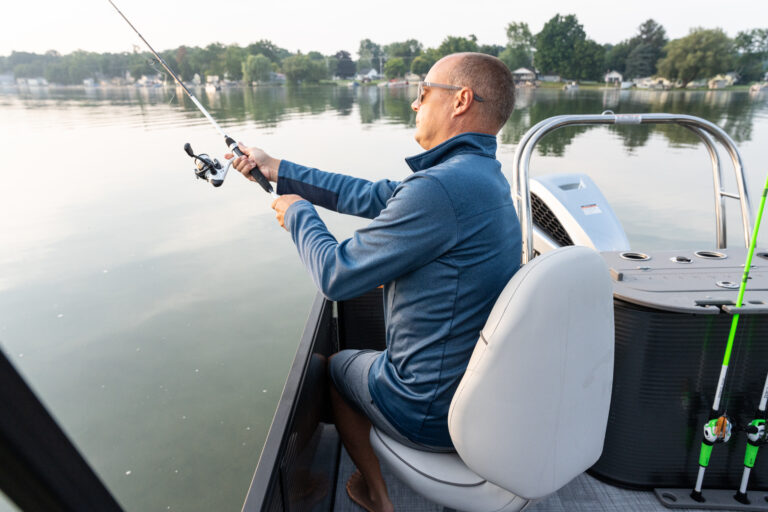 Qwest Pontoons E-Class XRE Cruise model features comfortable bench seating in the bow and rear fishing seats with fish station.